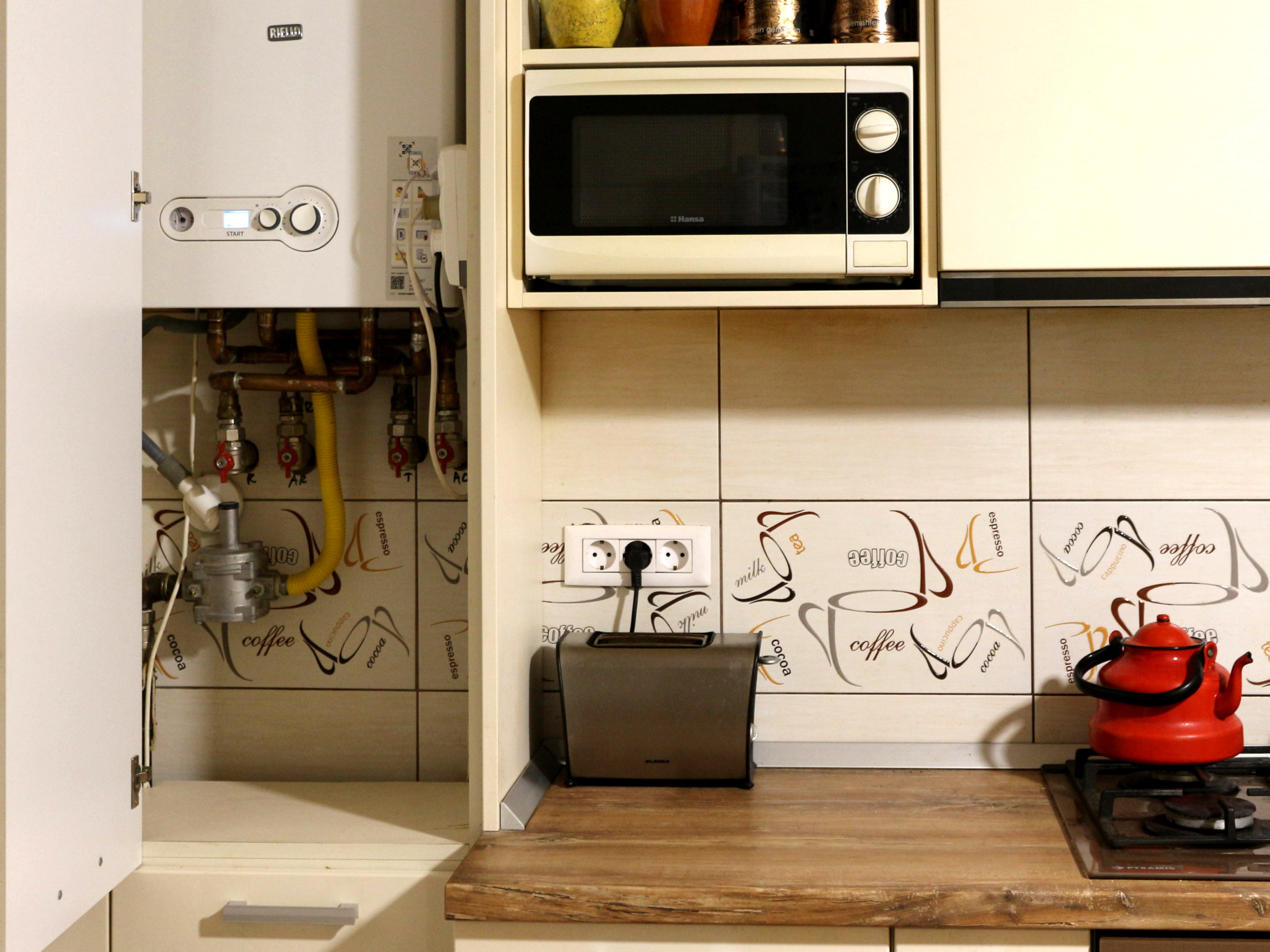 Wall mounted combi boiler in a home kitchen setting